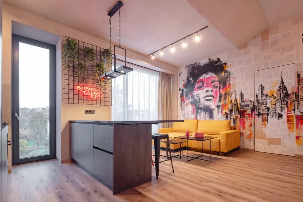 Farebne hravá obývačka s grafitmi, žltou pohovkou a svetlou vinylovou podlahou. 